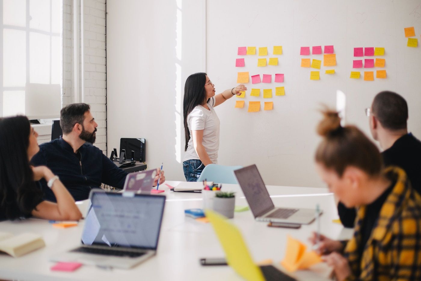 A team working through a problem together — hands-on AI enablement.